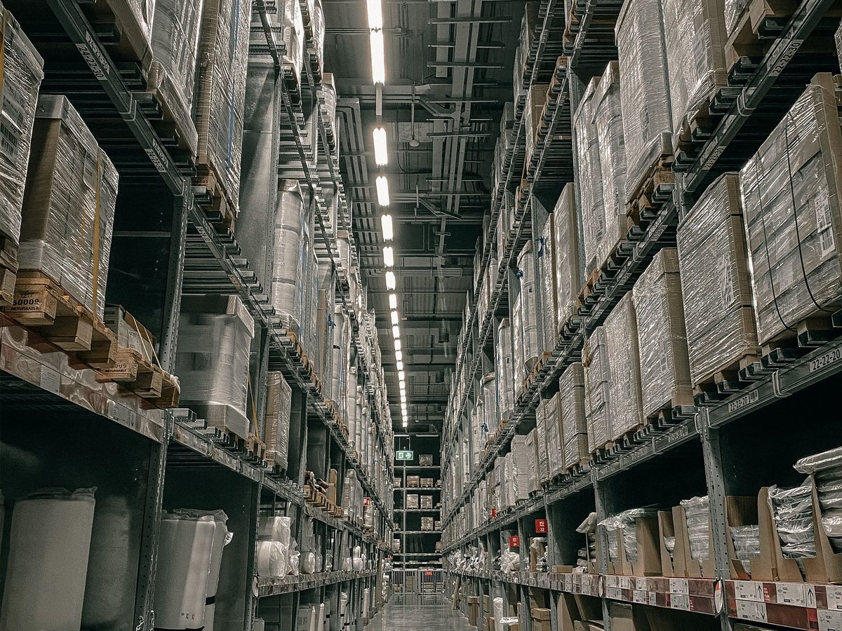 Long aisle inside a warehouse with high storage racks